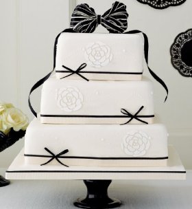 black and ivory cake finished with delicate flower stencils and monochrome ribbons