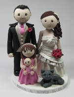 A wedding cake topper featuring all the family from Artlocke Designs