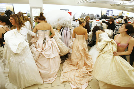 brides-to-be trying on their dream dresses  at the 'running of the brides' event in the US