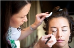 Katie Dale applying make-up to the bride on her big day