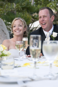 Bride and groom enjoying the bwst man's speech